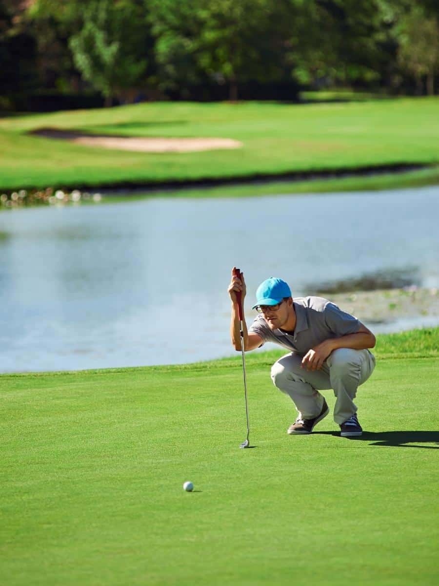 Golfer Checking a Putt